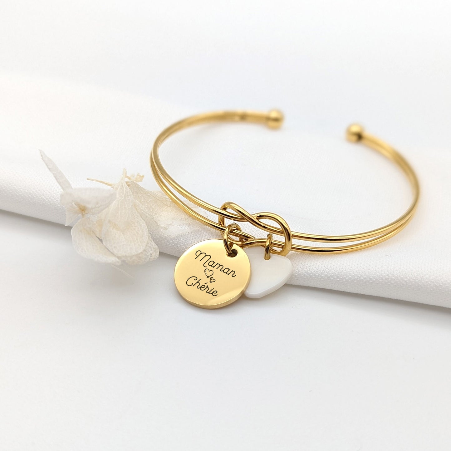Bracelet personnalisé jonc en acier inoydable avec médaille de 15mm à personnaliser et médaille nacrée au choix. Le bracelet est proposé en trois coloris différents et peut être personnalisé au recto et au verso.